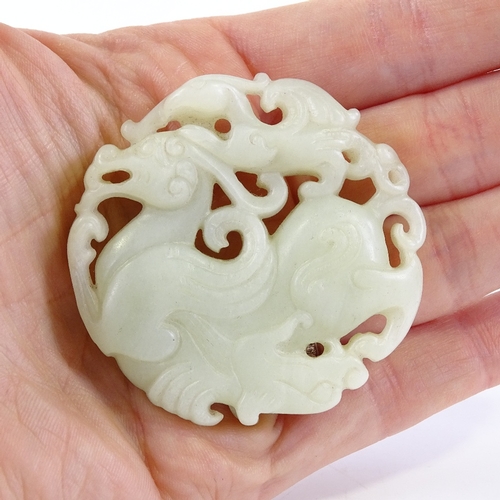 247 - A Chinese relief carved and pierced jade pendant, 5cm across