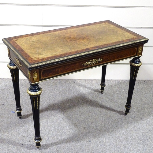 327 - A 19th century amboyna and walnut fold over card table, with gilt-bronze mouldings and mounts on tur... 