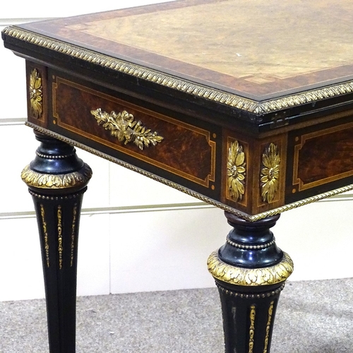 327 - A 19th century amboyna and walnut fold over card table, with gilt-bronze mouldings and mounts on tur... 