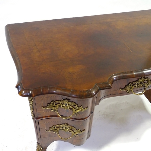 329 - An 18th century Italian (possibly Maltese) walnut desk, shaped moulded and banded top, with shaped c... 