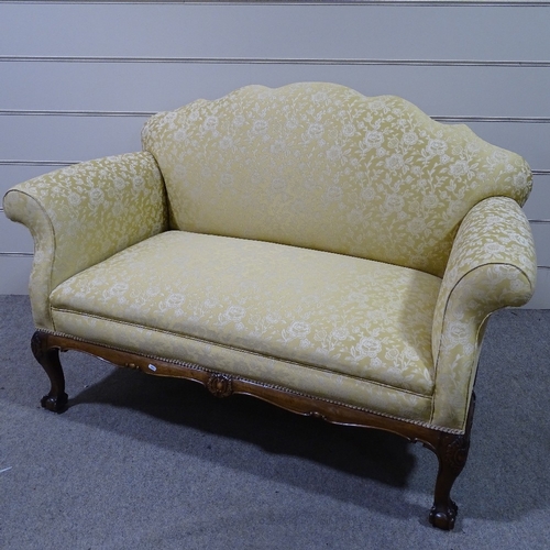 334 - An upholstered scroll-end sofa on carved mahogany base, length approx 5'