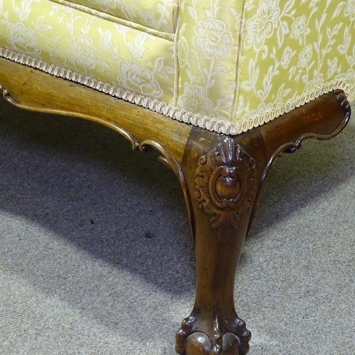 334 - An upholstered scroll-end sofa on carved mahogany base, length approx 5'