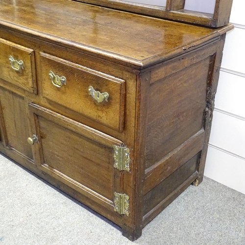 335 - An Antique oak dresser with open plate rack, 3 frieze drawers and panelled cupboards under, length 5... 