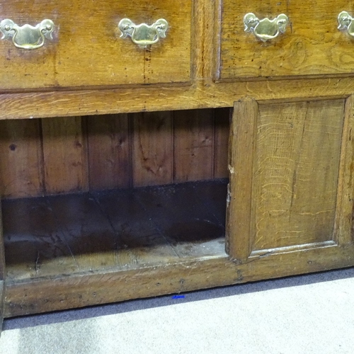 335 - An Antique oak dresser with open plate rack, 3 frieze drawers and panelled cupboards under, length 5... 