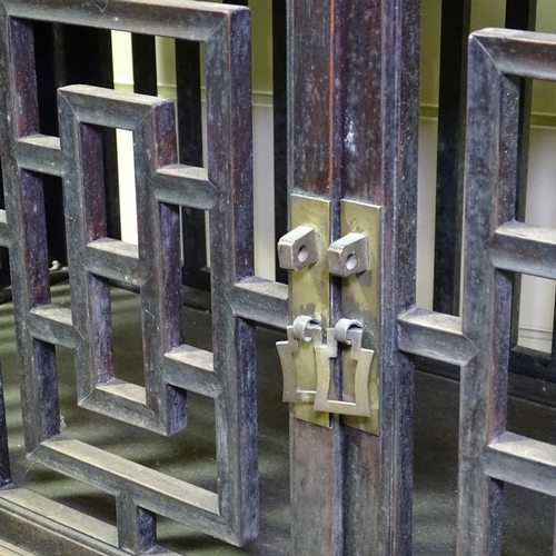 337 - A Chinese 19th century hardwood cupboard with fretwork panels and doors, width 3'11