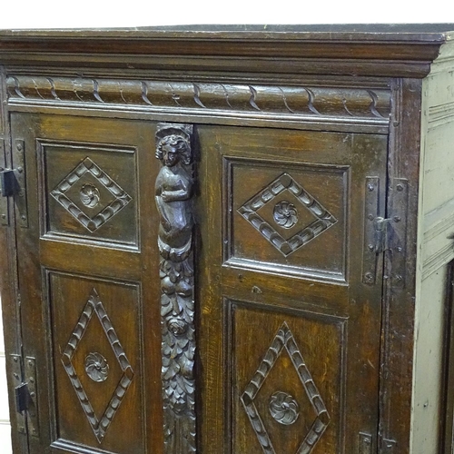 339 - An Antique carved and panelled oak 2-door cupboard on stand, 33.5