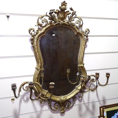 343 - An ornate 19th century gilt-gesso framed shield-shaped wall mirror, with 6 candle brackets, overall ... 