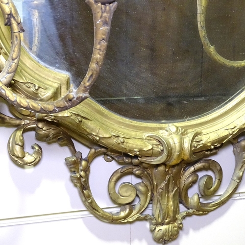 343 - An ornate 19th century gilt-gesso framed shield-shaped wall mirror, with 6 candle brackets, overall ... 