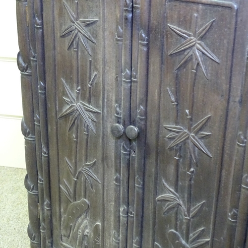 345 - A 19th century Chinese hardwood side cupboard, with relief carved bamboo decorated doors, width 18