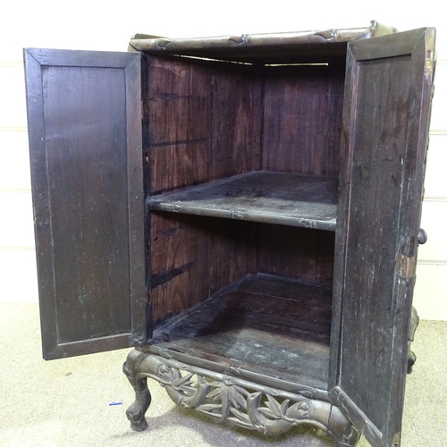 345 - A 19th century Chinese hardwood side cupboard, with relief carved bamboo decorated doors, width 18