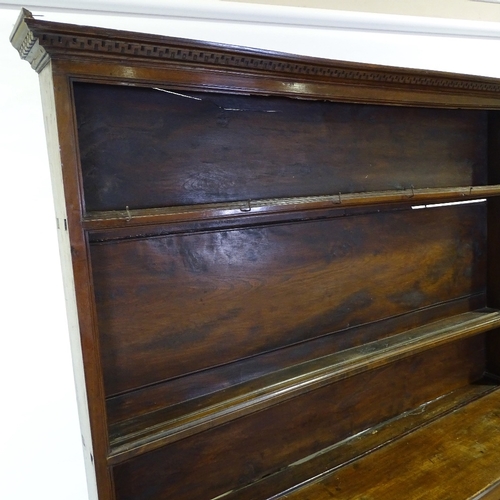 348 - An 18th century American (Virginian) walnut dresser, with boarded open plate rack above, 3 frieze dr... 