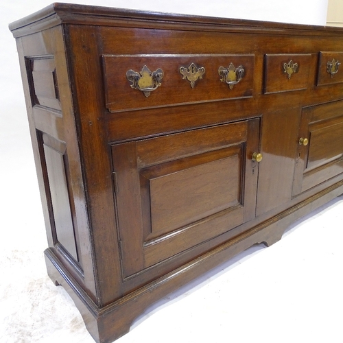 348 - An 18th century American (Virginian) walnut dresser, with boarded open plate rack above, 3 frieze dr... 