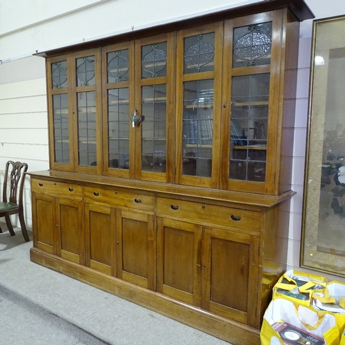 349 - An early 20th century mahogany library bookcase with leadlight glaze panelled cupboards above, friez... 