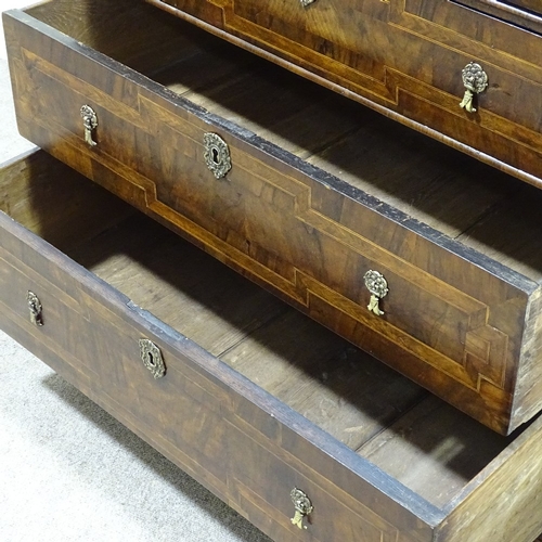 349B - An 18th century walnut chest of 3 long drawers, with feather-banded and quarter veneered top, concea... 