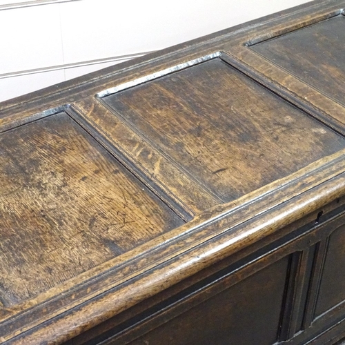 349G - An early 18th century panelled oak coffer, length 4'2