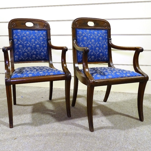 349N - A pair of Regency carved mahogany elbow chairs