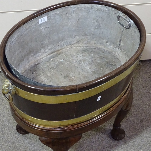 349S - An 18th century brass-bound walnut oval wine cooler, with brass lion-ring handles and cabriole legs,... 