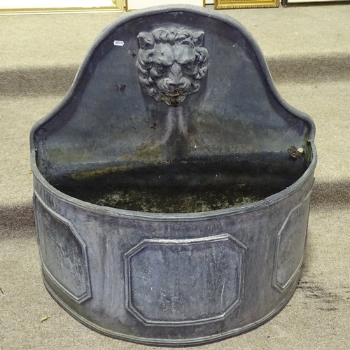 349T - A heavy semi-circular lead fountain with lion spout, width 2'7