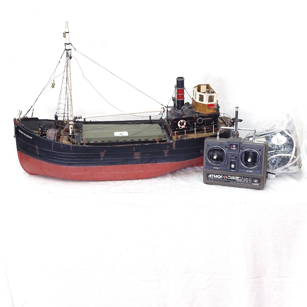 A large model remote control fishing boat, with remote, batteries and  charger, boat length 62cm