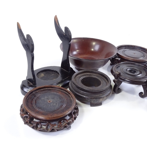 128 - A collection of Chinese hardwood stands, and a lacquer bowl, diameter 14.5cm