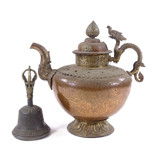 190 - An ornate Tibetan brass and copper kettle with dragon handle, height 28cm, and a Tibetan hand bell (... 