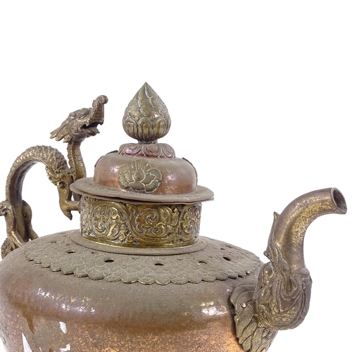 190 - An ornate Tibetan brass and copper kettle with dragon handle, height 28cm, and a Tibetan hand bell (... 