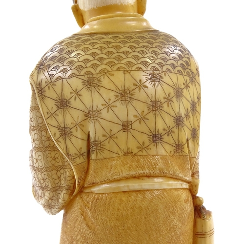 2 - A Japanese 2-tone stained ivory okimono, man carrying an infant, Meiji period, signed under base, he... 