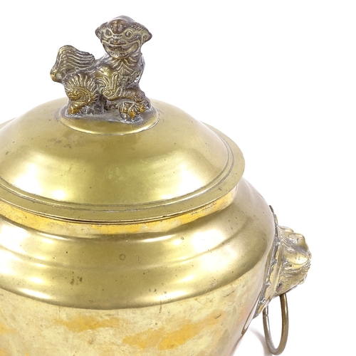 24 - A Chinese polished bronze bowl and cover with lion ring handles, surmounted by a Dog of Fo, height 2... 