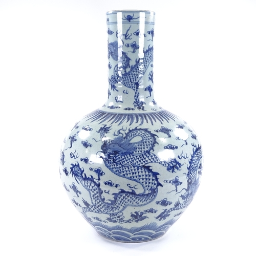35 - A large Chinese blue and white porcelain narrow-necked vase, with hand painted dragon decoration, he... 