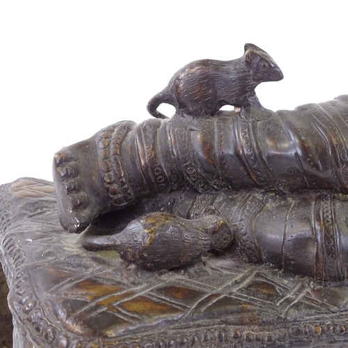 46 - A large reproduction Indian heavy gauge patinated bronze figure of Ganesh reclining on a couch, leng... 