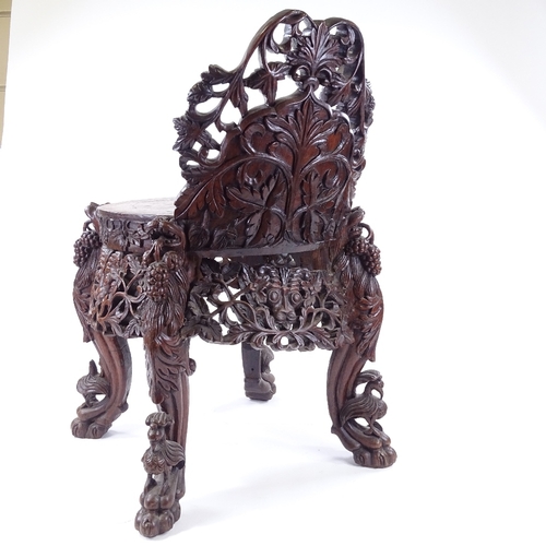 84 - A 19th century Burmese hardwood chair, allover carved and pierced decoration with lion masks and lio... 