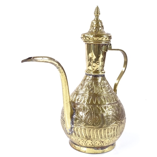 93 - An Islamic brass wine ewer with relief embossed design, height 33cm