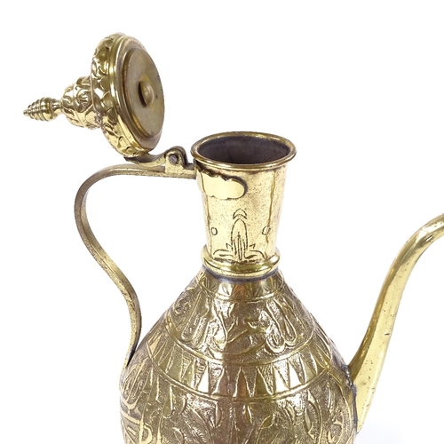 93 - An Islamic brass wine ewer with relief embossed design, height 33cm