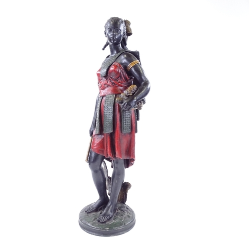 99 - A patinated and painted spelter figure of a West Indian woman carrying a pineapple, height 51cm