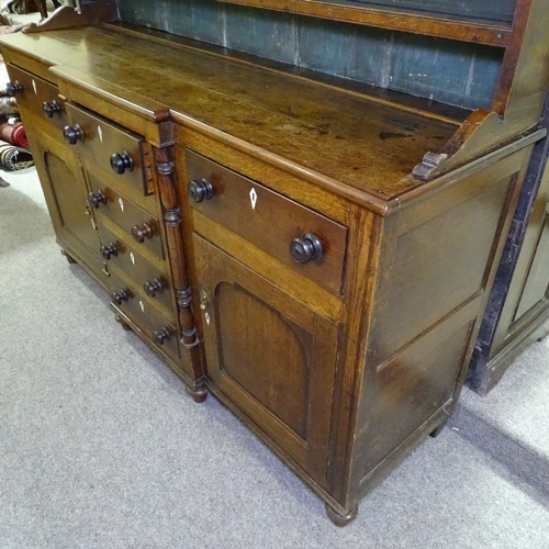 335 - A George III oak and mahogany break-front Anglesea Welsh dresser, with boarded open plate rack and d... 