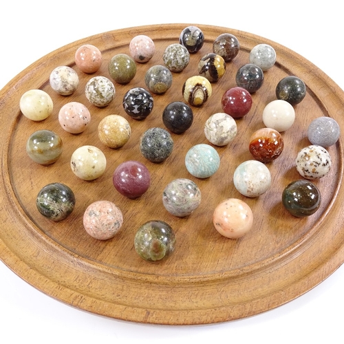 235 - A solitaire board, diameter 32cm, together with a set of marble and hardstone balls, diameter 25mm