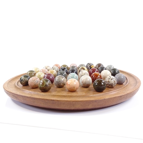 235 - A solitaire board, diameter 32cm, together with a set of marble and hardstone balls, diameter 25mm