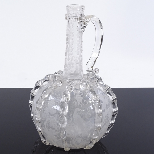 238 - A Venetian style clear glass wine flagon, with vertical trials and engraved birds, height 20cm