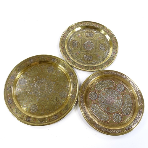 242 - 3 Islamic brass plates with silver and copper inlaid decoration and text, largest 31cm across (3)