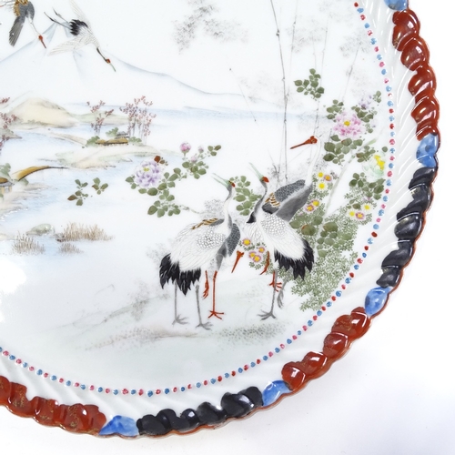 243 - A Japanese porcelain tray with hand painted scene depicting cranes in mountain landscape, signed on ... 