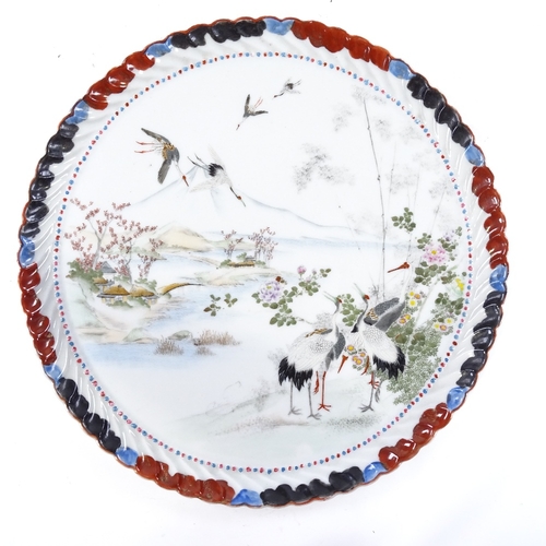 243 - A Japanese porcelain tray with hand painted scene depicting cranes in mountain landscape, signed on ... 