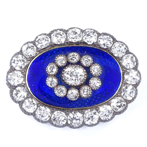 450 - An Antique unmarked gold royal blue enamel and diamond cluster oval pendant / brooch, central engine... 