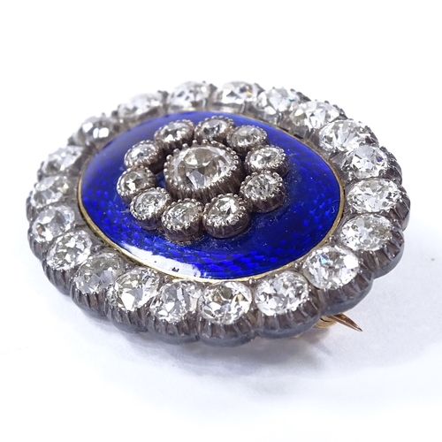 450 - An Antique unmarked gold royal blue enamel and diamond cluster oval pendant / brooch, central engine... 