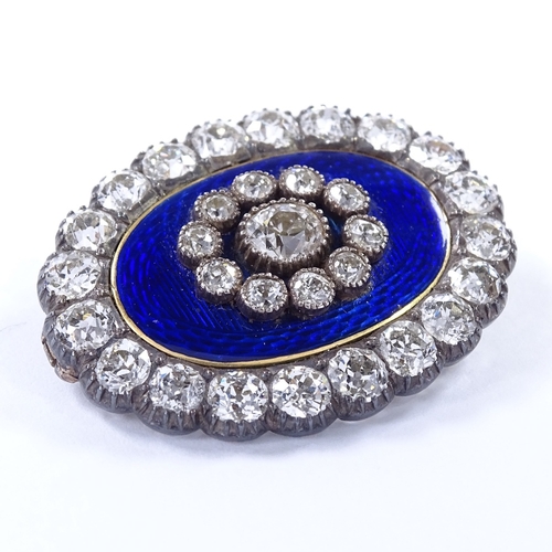 450 - An Antique unmarked gold royal blue enamel and diamond cluster oval pendant / brooch, central engine... 