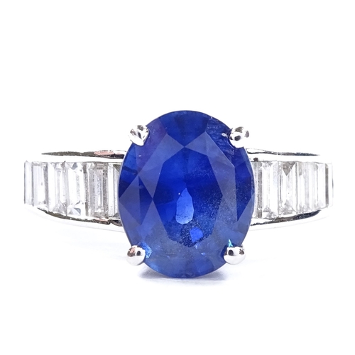 451 - An unmarked white gold sapphire and baguette-cut diamond ring, oval-cut sapphire approx 4ct, total d... 