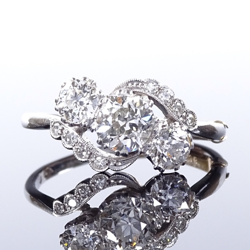 452 - A platinum 3-stone diamond crossover ring, with diamond set shoulders, central stone approx 0.95ct, ... 