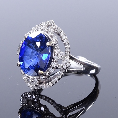 457 - A 14ct white gold sapphire and diamond cluster ring, oval-cut sapphire approx 4.5ct, pierced setting... 