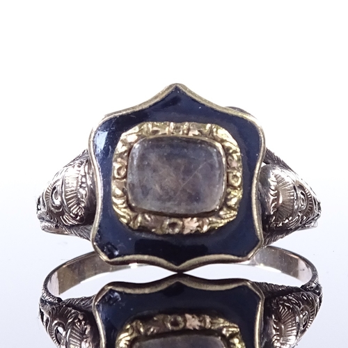 459 - A 19th century unmarked gold and black enamel mourning ring, central glass-fronted shield-shaped pan... 