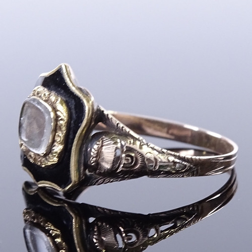 459 - A 19th century unmarked gold and black enamel mourning ring, central glass-fronted shield-shaped pan... 