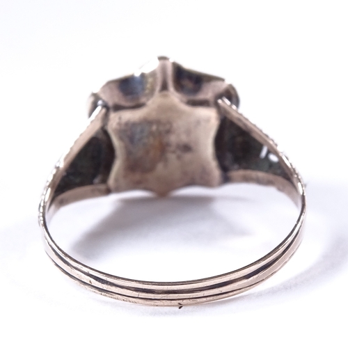 459 - A 19th century unmarked gold and black enamel mourning ring, central glass-fronted shield-shaped pan... 